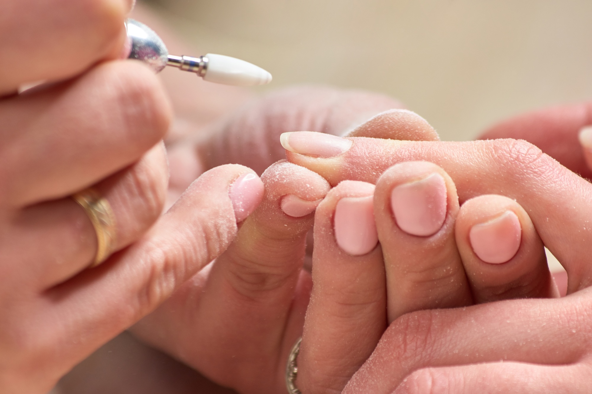 Manicurist making hardware manicure