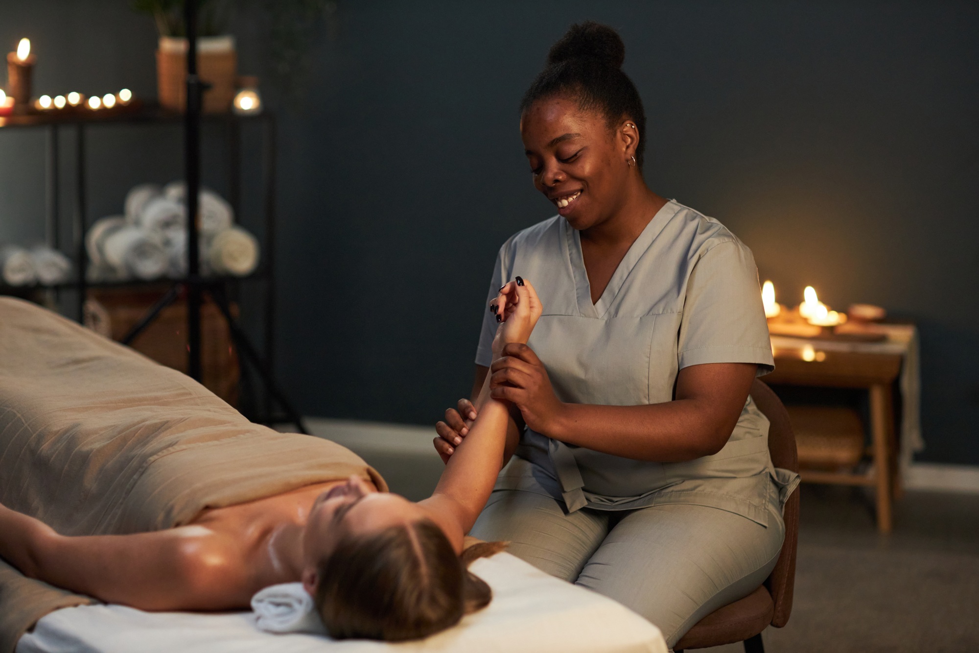 Smiling Masseuse Providing Relaxing Massage Therapy